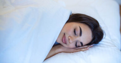 Young caucasian woman sleeping in the bed relaxed calm dreams