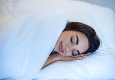 Young caucasian woman sleeping in the bed relaxed calm dreams