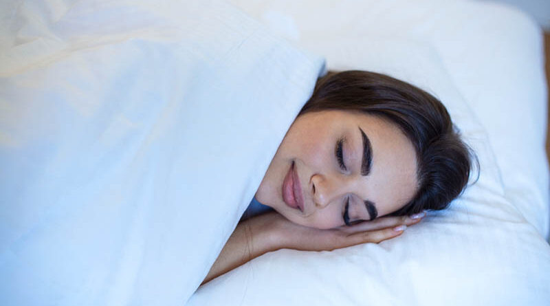 Young caucasian woman sleeping in the bed relaxed calm dreams